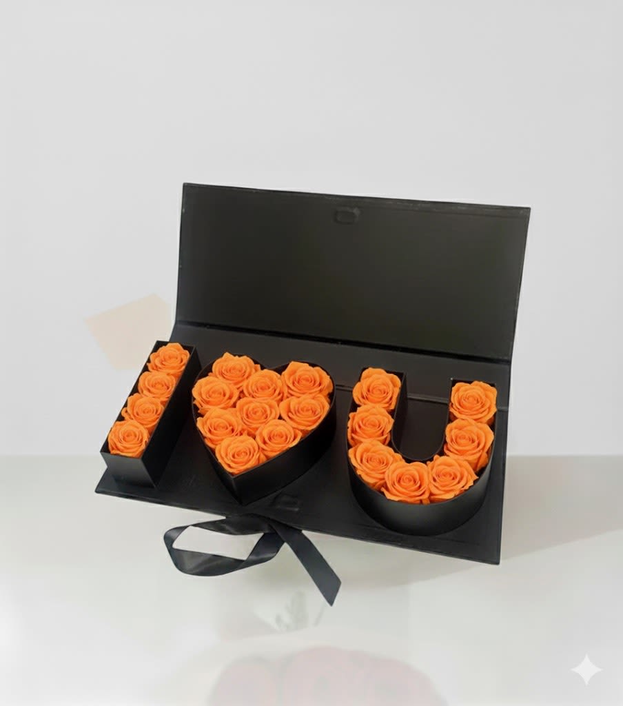 Black gift box with orange roses arranged as I love you