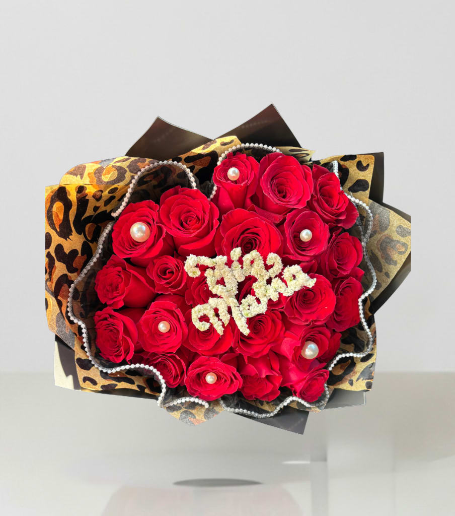 Bouquet of red roses with pearl accents and leopard-print wrapping