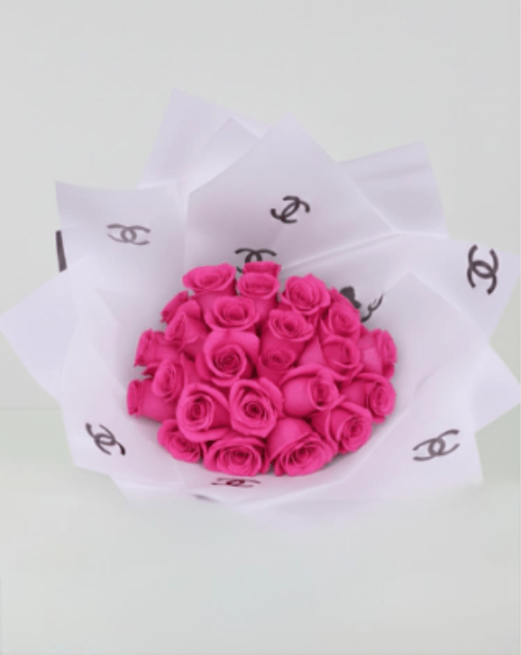 Bouquet of bright pink roses wrapped in white paper