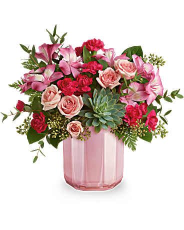 Pink and red mixed bouquet in a pink glass vase