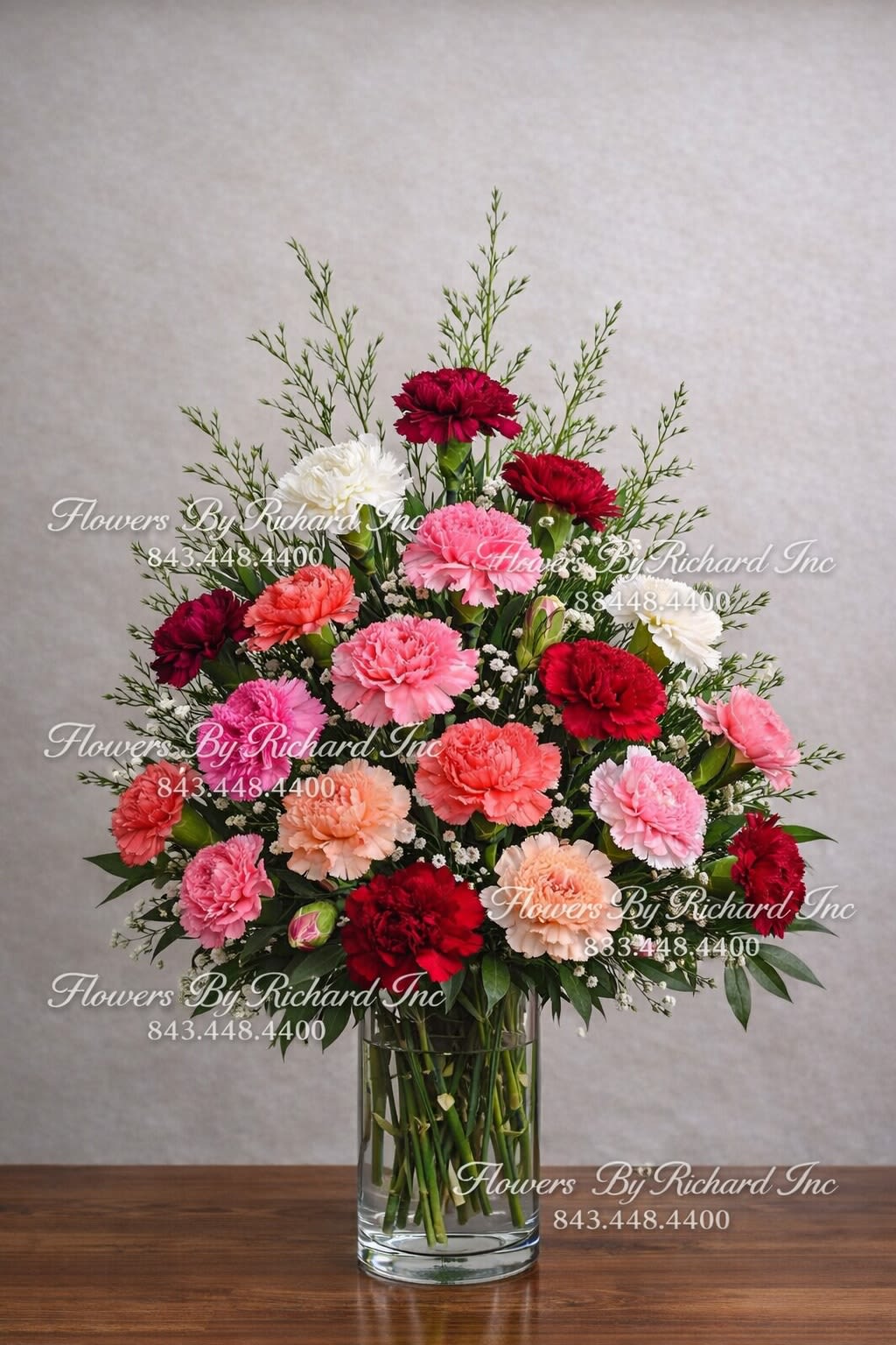Mixed carnations in a clear glass vase