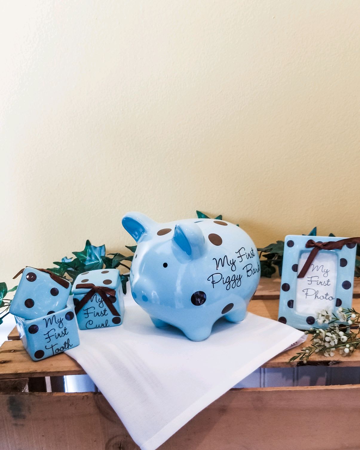 Blue polka-dot baby keepsakes on a wooden table