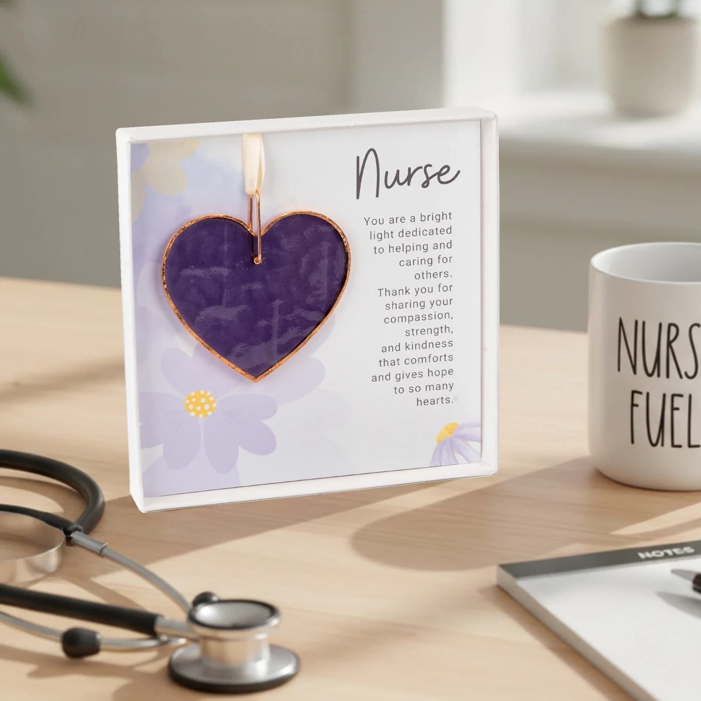 Nurse Keepsake Gift – Handmade Stained Glass Heart - Are you searching for a gift for a special nurse that tells them how much you appreciate them? If you are looking for the words, when they are hard to find, let our beautiful handmade glass heart do the talking for you!  This handcrafted textured stained glass purple heart ornament is handmade in the USA. The 3" glass heart is lined with copper edging and features a copper ring with satin ivory ribbon for hanging at any time of year. Each heart has ripples and textures that are inherent in handmade glass adding beauty and character to each piece. It would look amazing on their desk, in their kitchen window, sunroom, or other favorite spot or as a treasured holiday ornament they would cherish each year.  Each stained-glass heart is paired with a touching original sentiment written by Teri Harrison. The Nurse sentiment is printed on quality cardstock paper and presented in a 5.5"x5.5" white linen box with a clear lid. All components made in the USA.  Copyright Teri Harrison  