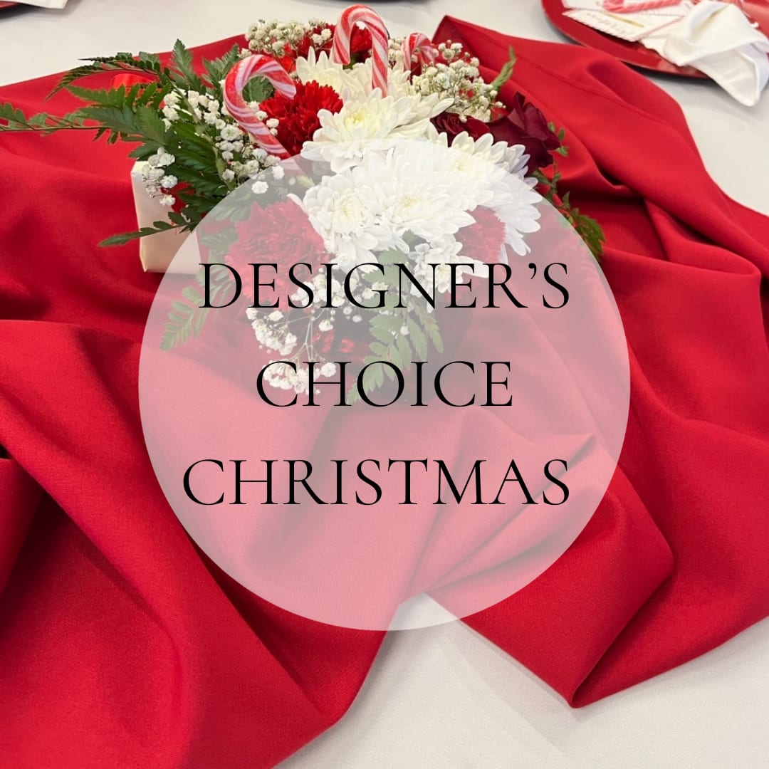 Christmas bouquet with red and white flowers on red fabric