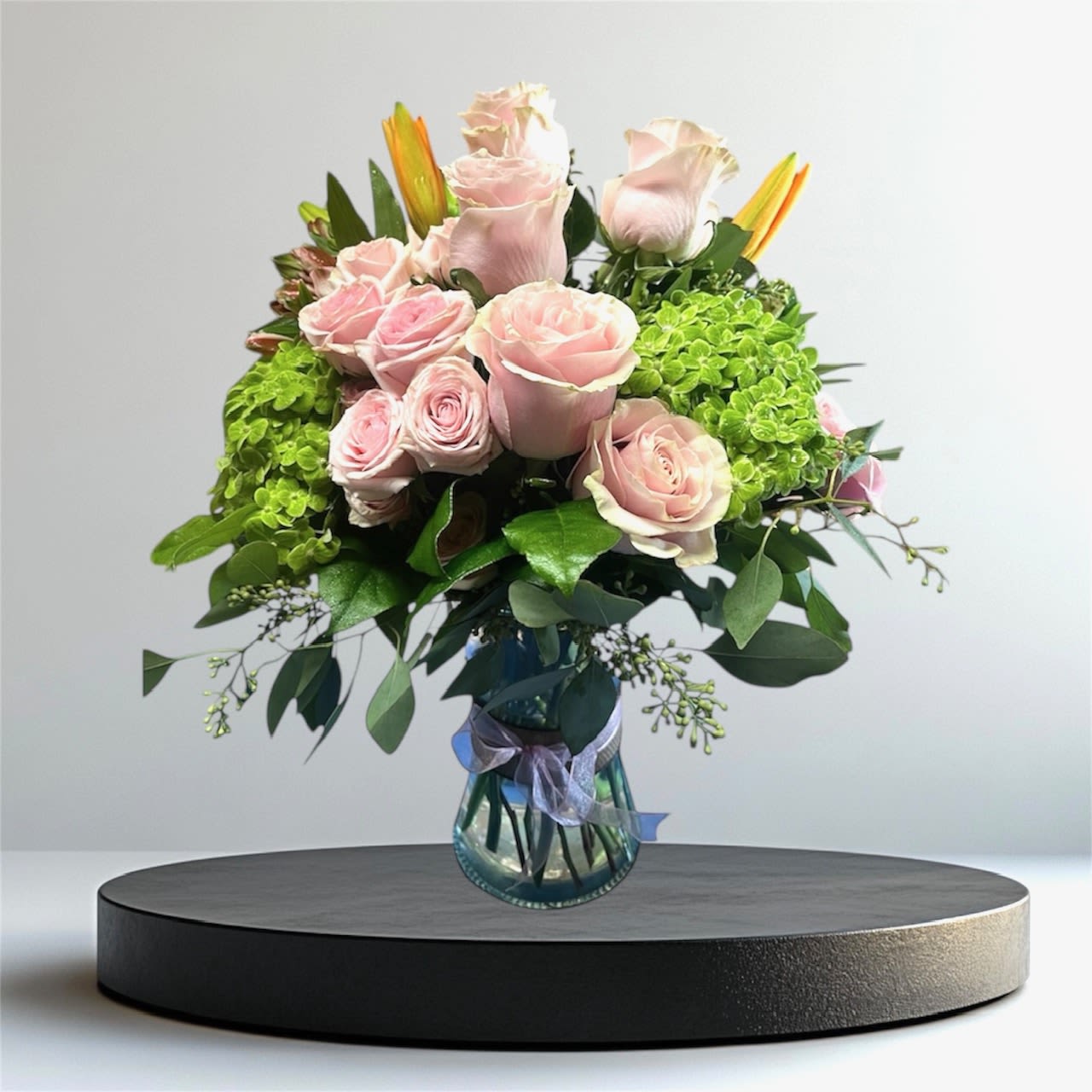 Pink roses and green hydrangeas in a glass vase