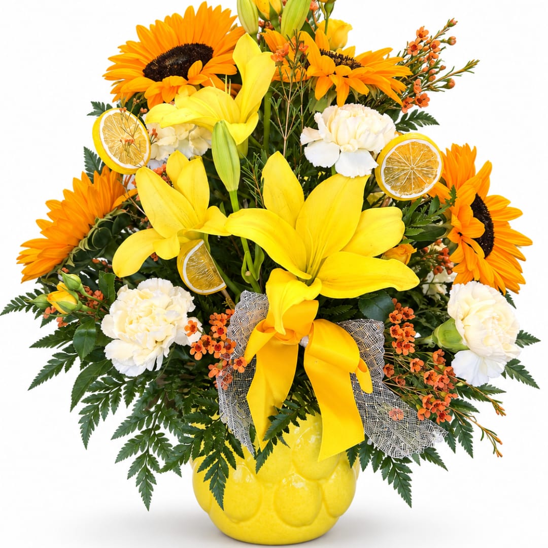 Yellow lilies and sunflowers in a yellow vase with white carnations