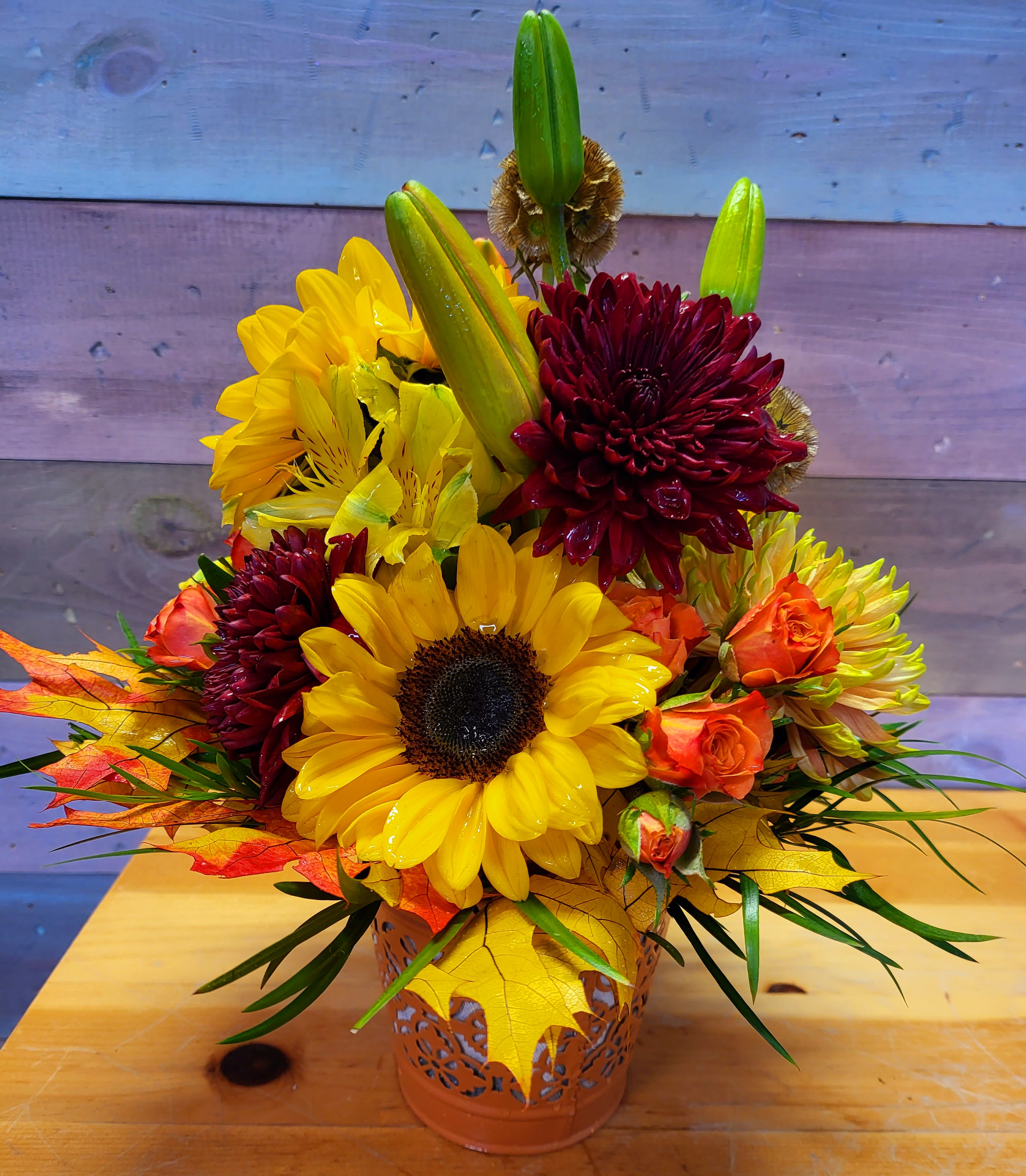Sunflower and chrysanthemum arrangement in a decorative metal container