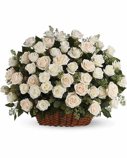 Basket of white roses with pale peach accents