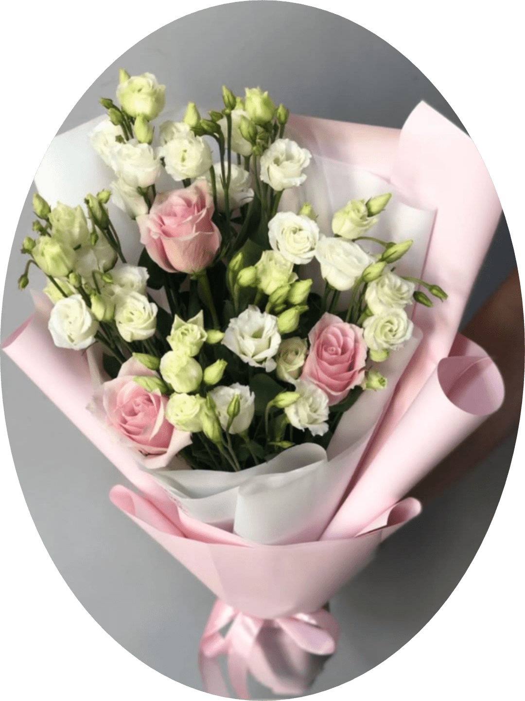 Pink Rose and White Lisianthus Bouquet - Soft pink roses paired with clusters of white lisianthus create a gently romantic birthday bouquet or anniversary gift that reads as fresh, feminine, and effortlessly elegant. The hand-tied presentation and airy mix of open blooms and tight buds make it the kind of bouquet that will make her feel genuinely celebrated-perfect for Mother's Day, a thoughtful romantic gesture, or any moment you want to mark with soft beauty.  Wrapped in layered pale pink and white decorative paper with a pink satin ribbon and floral wrap, this arrangement offers a polished, gift-ready look. The contrast of the white inner wrap brightens the bouquet while the decorative paper and ribbon add a tactile, luxurious finish-ideal for giving straight from the shop or sending to someone special.