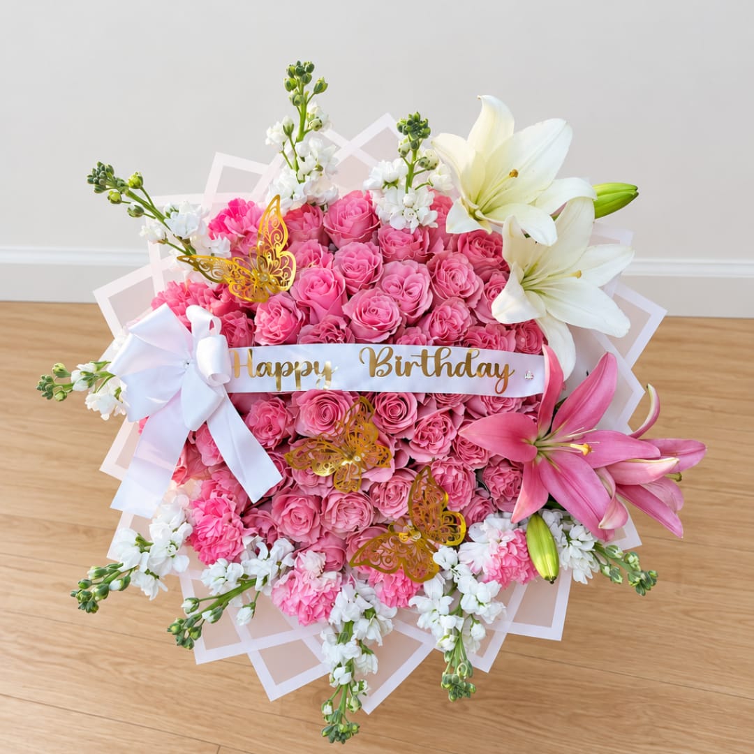 Pink rose bouquet with white lilies and a birthday ribbon