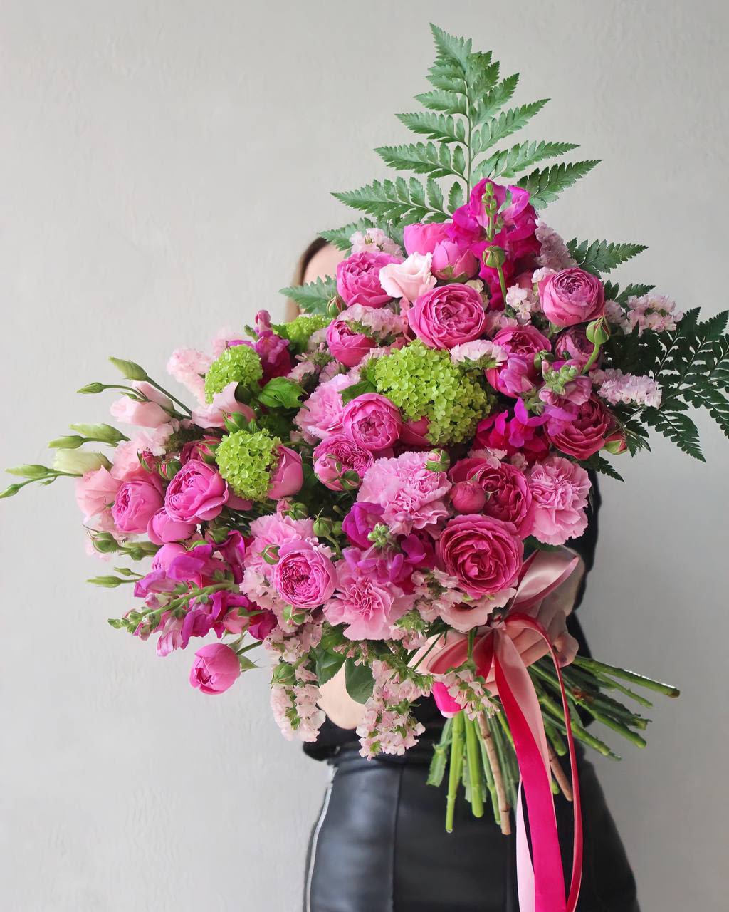 Large pink bouquet with roses and carnations tied with ribbon