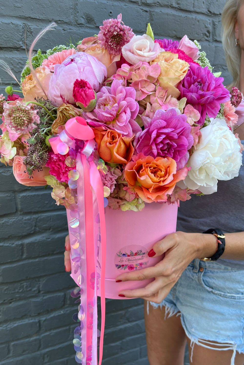 Pink and orange mixed bouquet in a pink box with ribbon