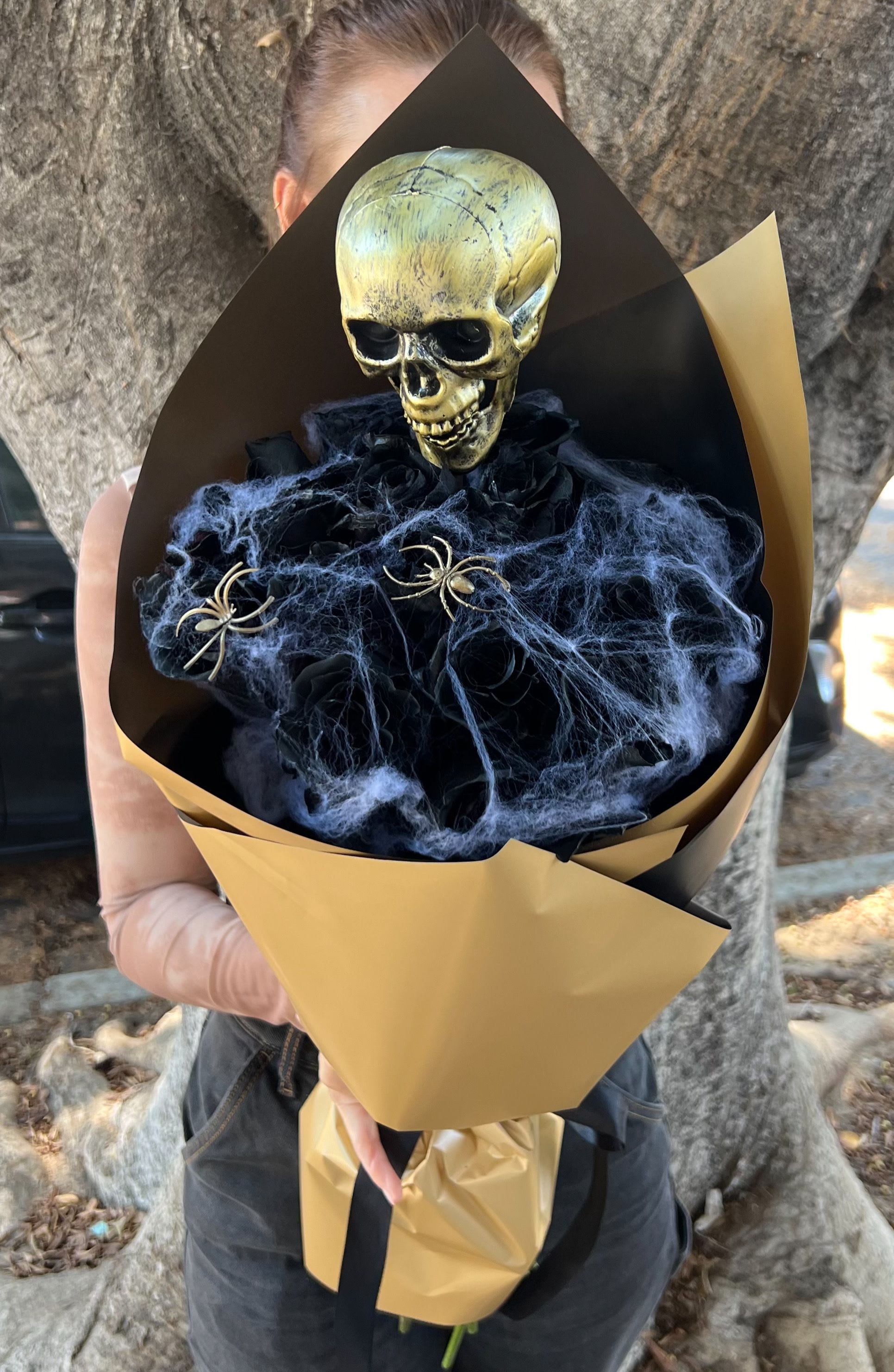 Halloween bouquet with a skull topper and black spiderweb accents