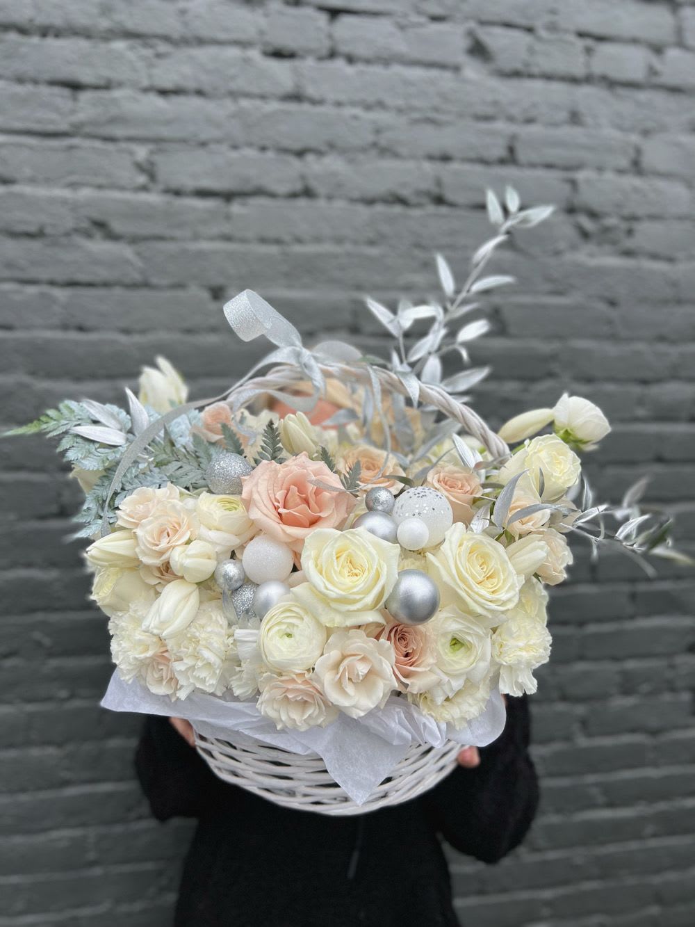 Cream and blush bouquet in a white basket with silver accents