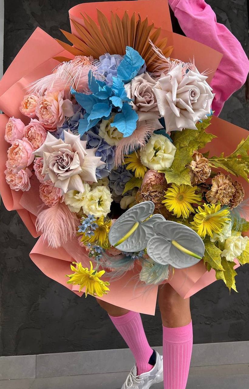 Large mixed bouquet with pastel roses and yellow daisies wrapped in pink paper
