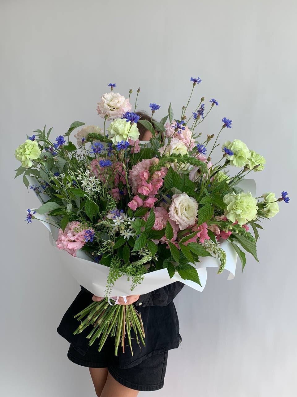 Large bouquet of pink and white flowers with blue accents