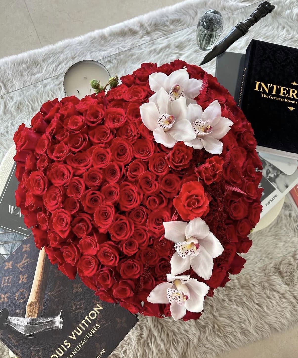 Heart-shaped arrangement of red roses with white orchids