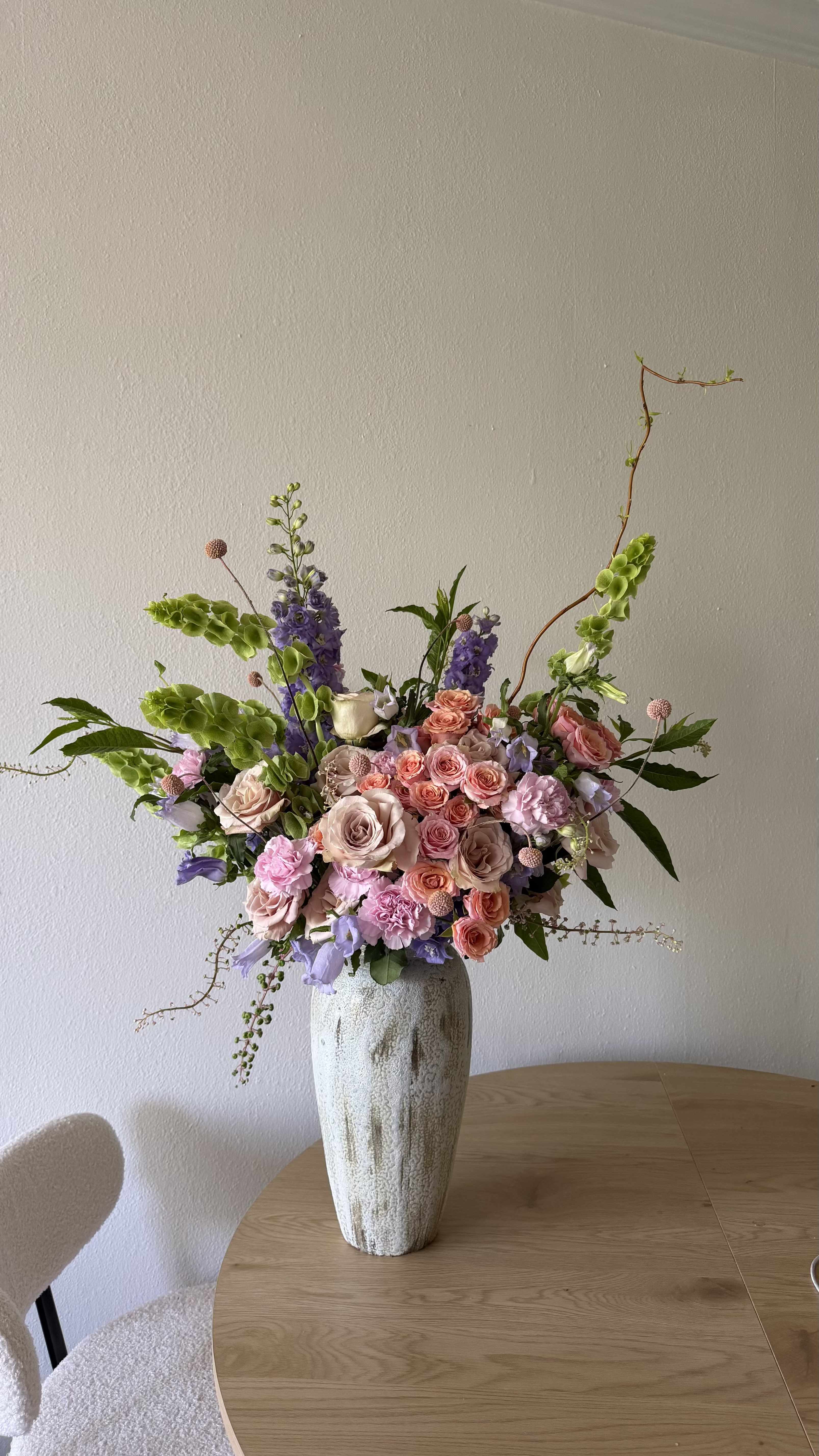 Sunset Blush - Modern ceramic vase full of Spray roses, Delphinium, and other mixed roses