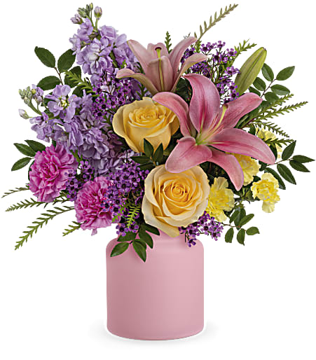 Pink lilies and yellow roses in a pink vase