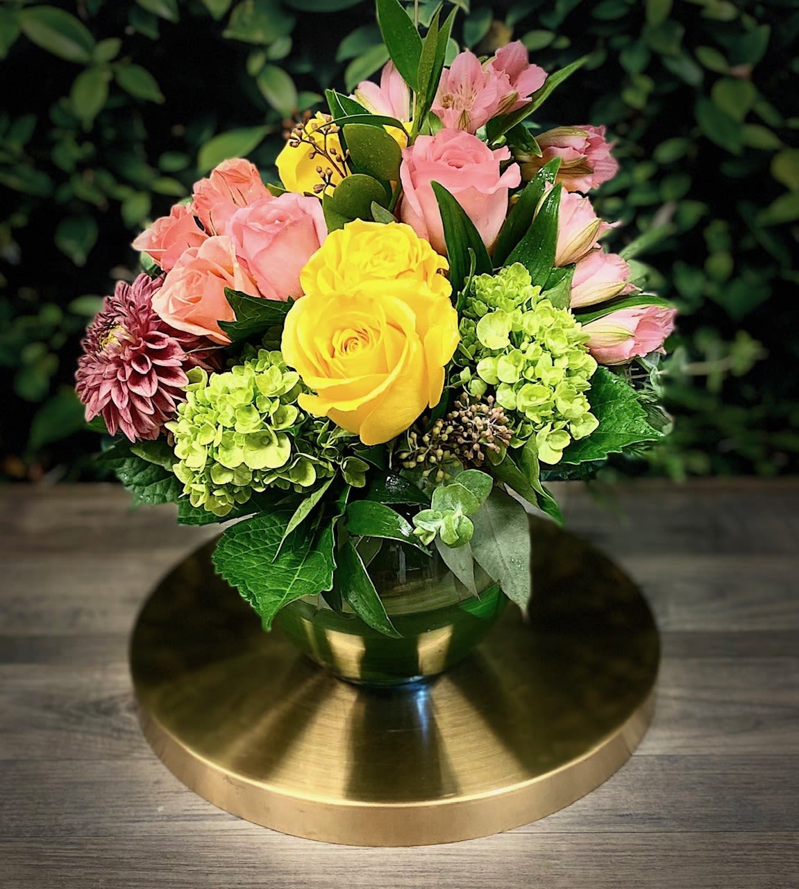 Bouquet of yellow and pink roses in a glass vase