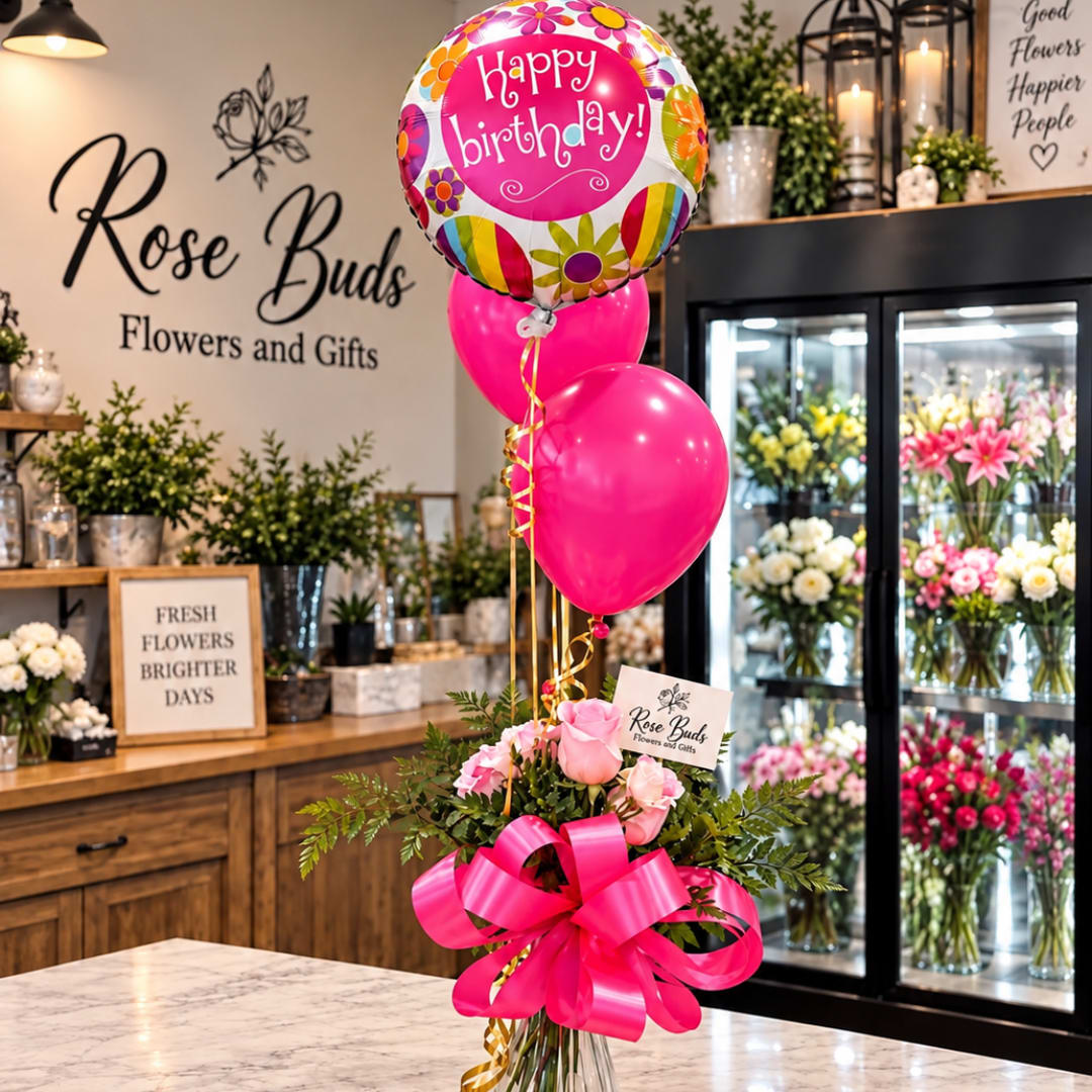 Pink rose bouquet with birthday balloons in a glass vase