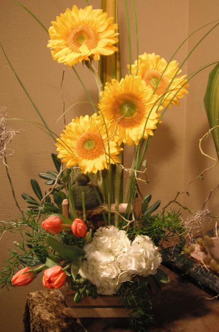 Tall floral arrangement with yellow gerbera daisies and coral tulips