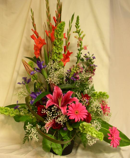 Tall mixed flower arrangement with pink lilies and gerbera daisies in a vase