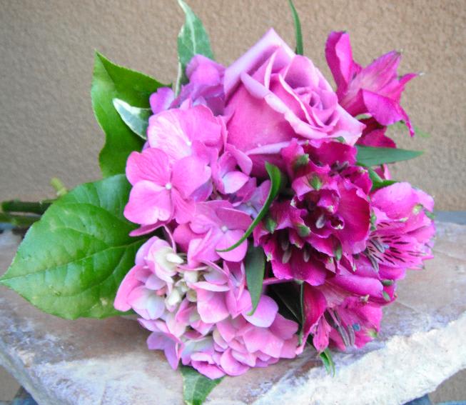 Pink rose and hydrangea bouquet with green leaves