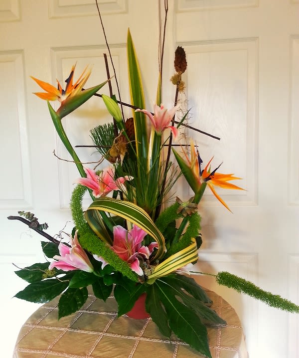 Tall tropical arrangement with pink lilies and orange bird-of-paradise flowers