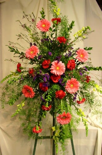 Tall standing floral spray with pink and red blooms