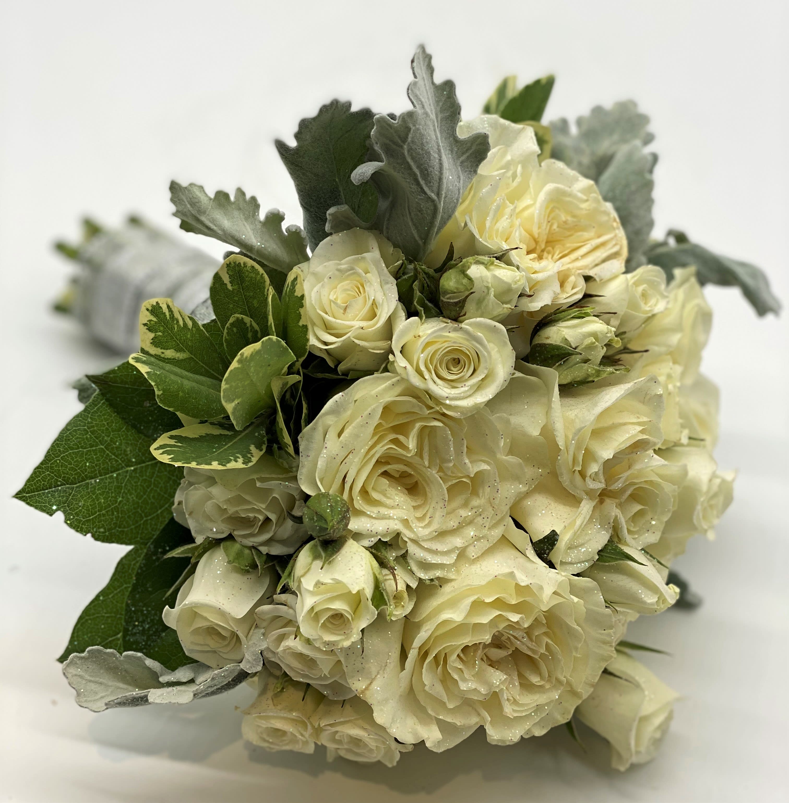 The Elegant Shimmer Clutch Bouquet - A lush mix of whites and creams, with dusty miller accent and finished off with glitter dusting!