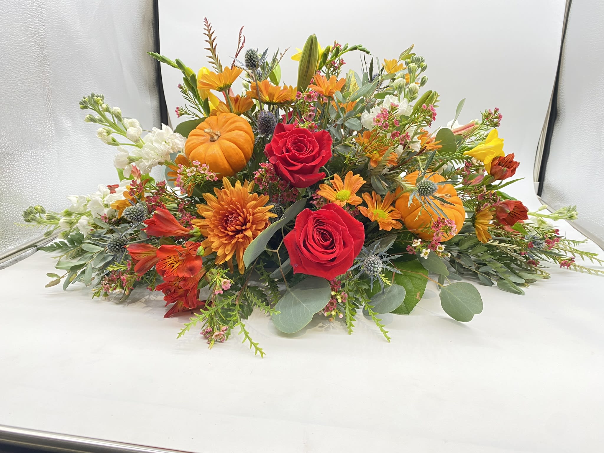 The Thankful Seasonal Soiree - This floral creation has seasonal hints and tones of oranges and reds....