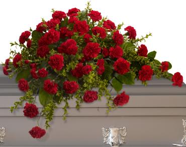 Large arrangement of red carnations with green filler on a ledge