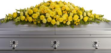 Yellow floral spray on a silver casket