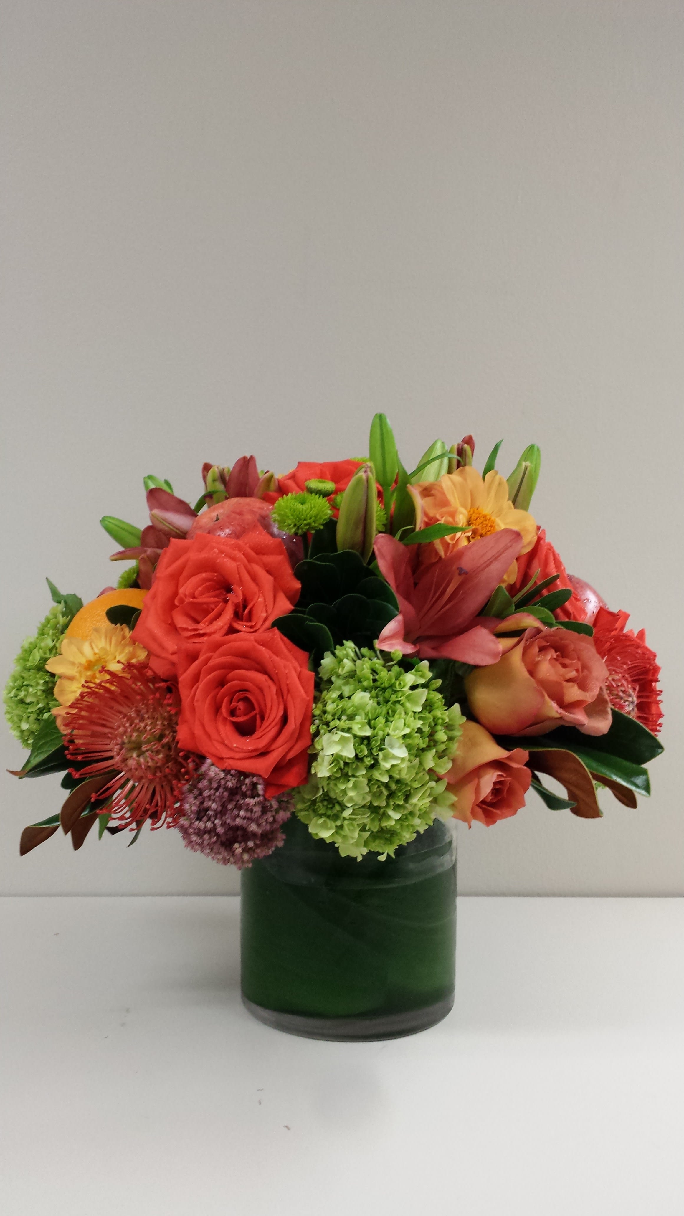 Chic Tropics - A chic and sophisticated tropical arrangement featuring seasonal blooms in a leaf wrapped vase.