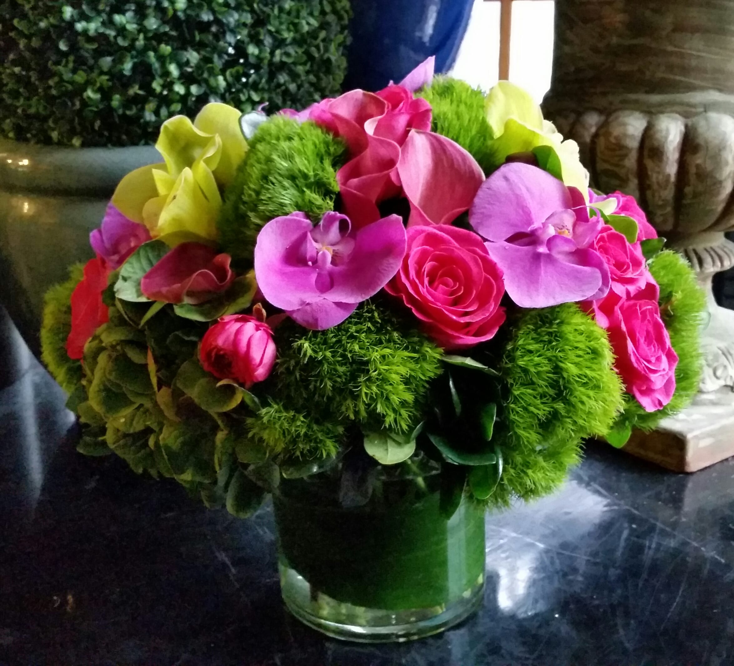 Bright pink and purple bouquet in a glass vase