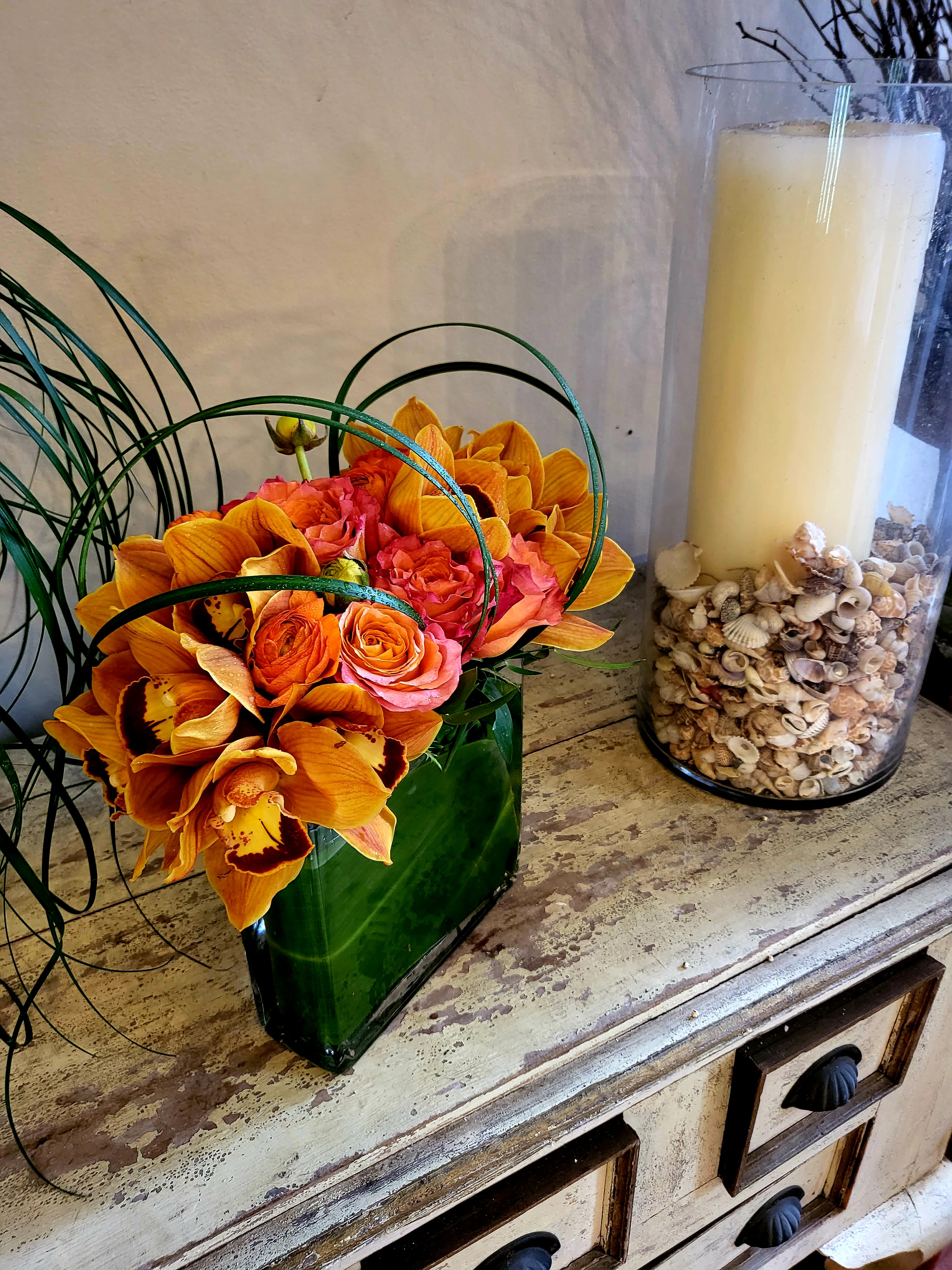 Sunset - A modern arrangement of orchids and roses in a beautiful orange pallet 