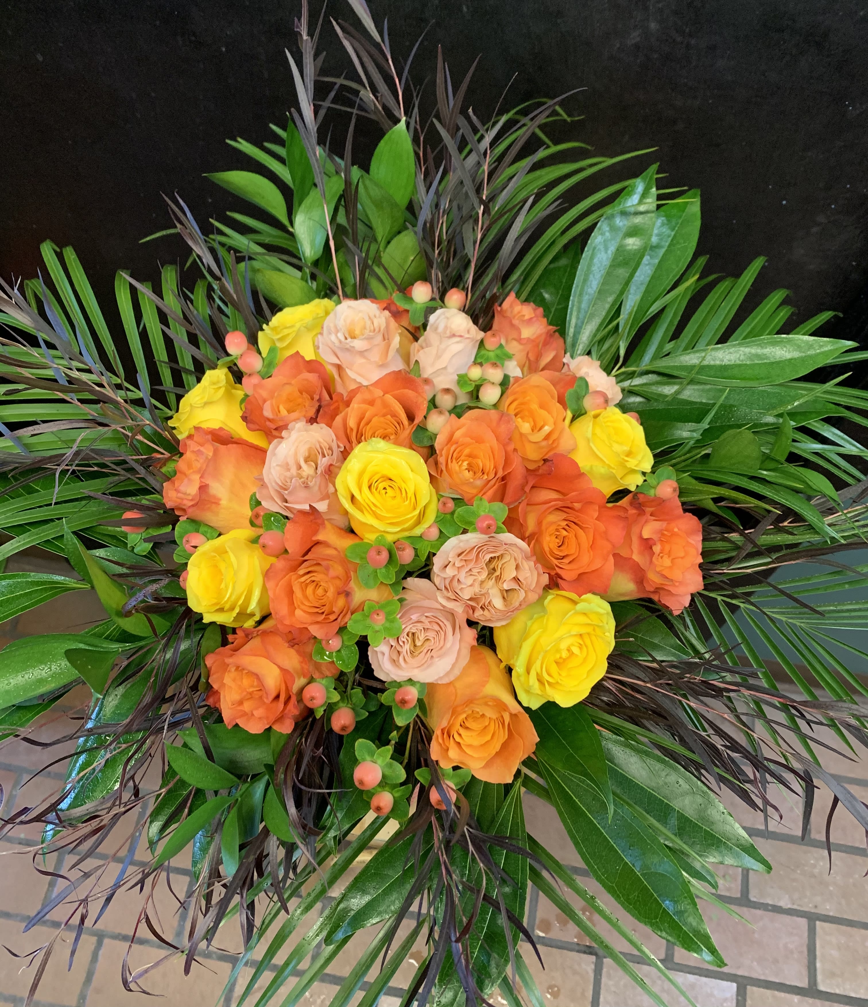 Love you to the moon! - 2 dozen of our finest roses hand tied in a nice cylinder with tropical foliages. You can specify a color palette, but if you leave it up to us, we will pick the finest roses available. 