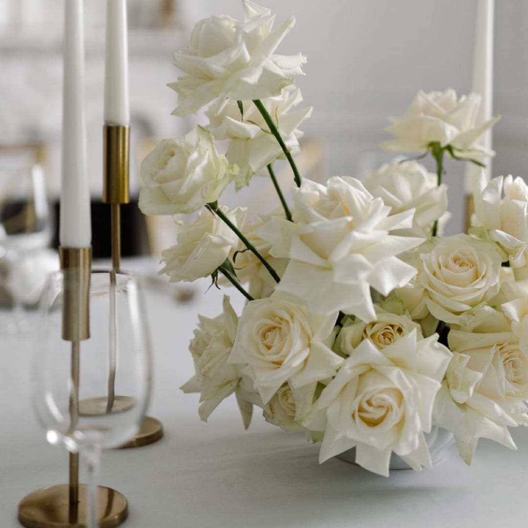 White rose bouquet with star-shaped blooms in a low vase