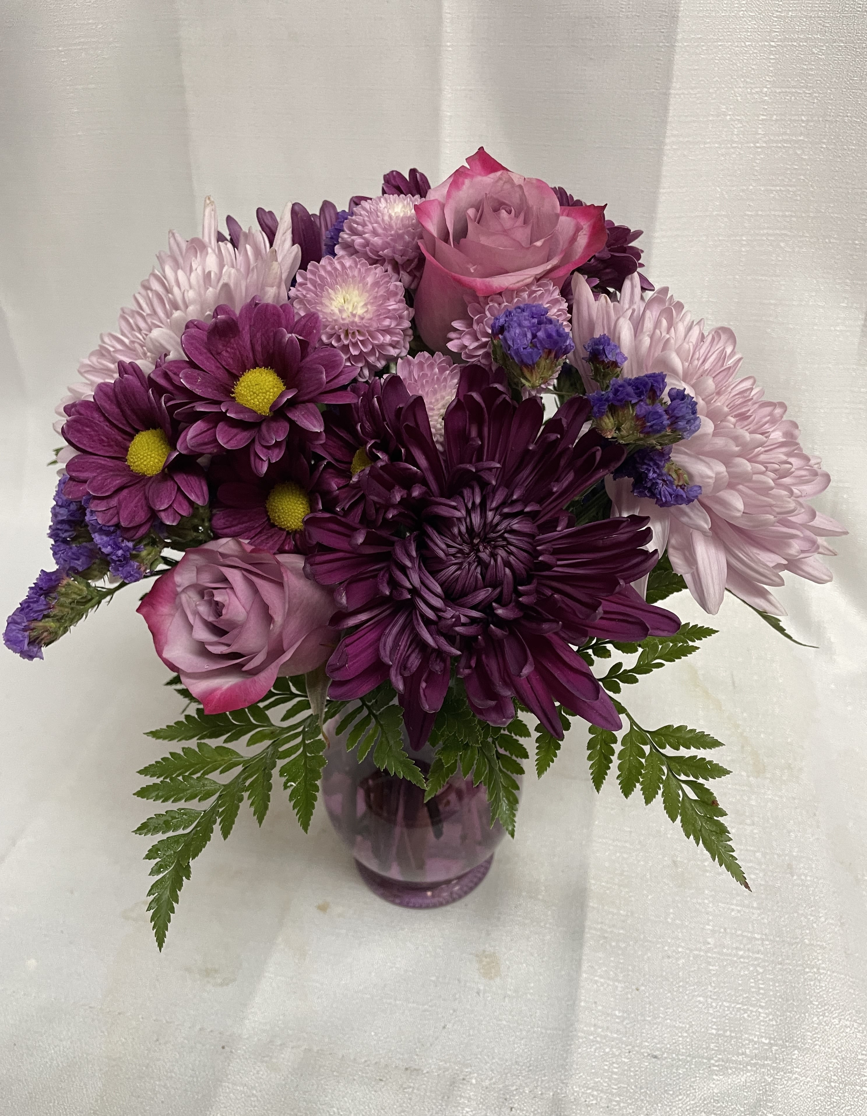 Purple and pink bouquet in a glass vase