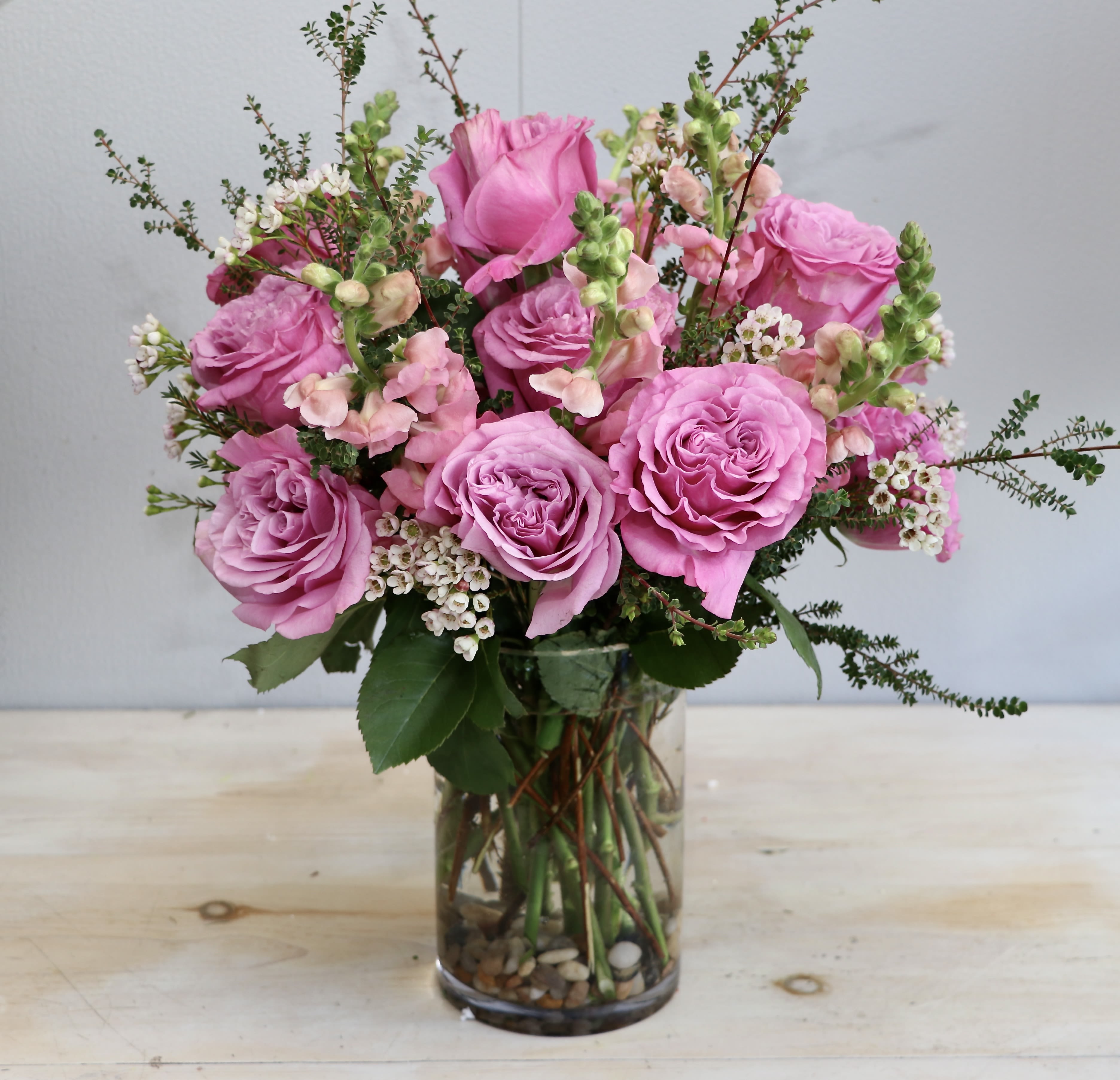 Springtime Sunrise - My Glendale Florist - This arrangement is filled with vibrant roses, snap dragons and seasonal greens. All made in a lovely tall vase.