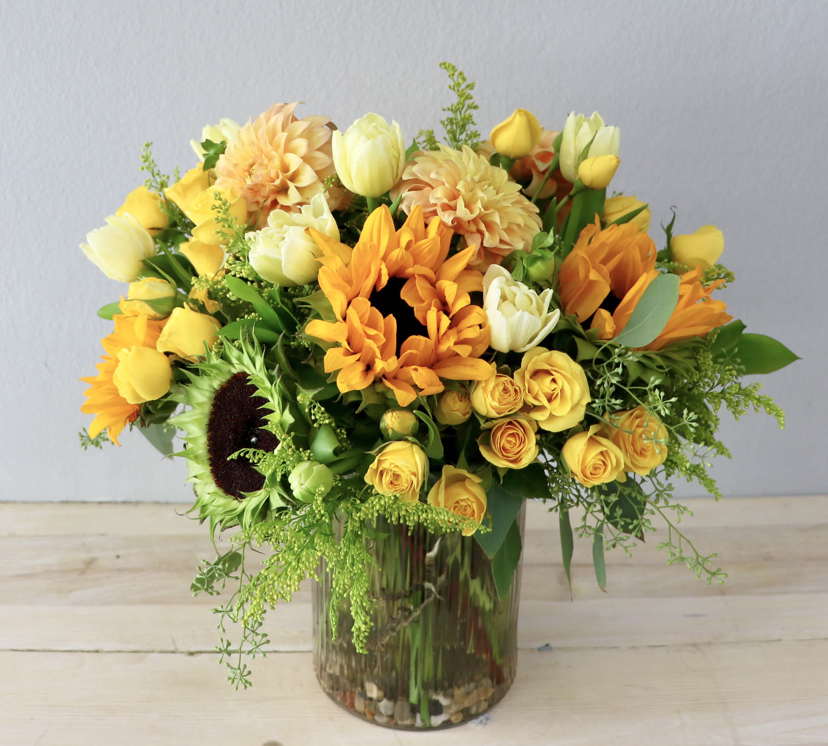 Yellow and orange mixed bouquet in a glass vase