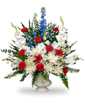 Red, white, and blue floral arrangement in a pedestal vase