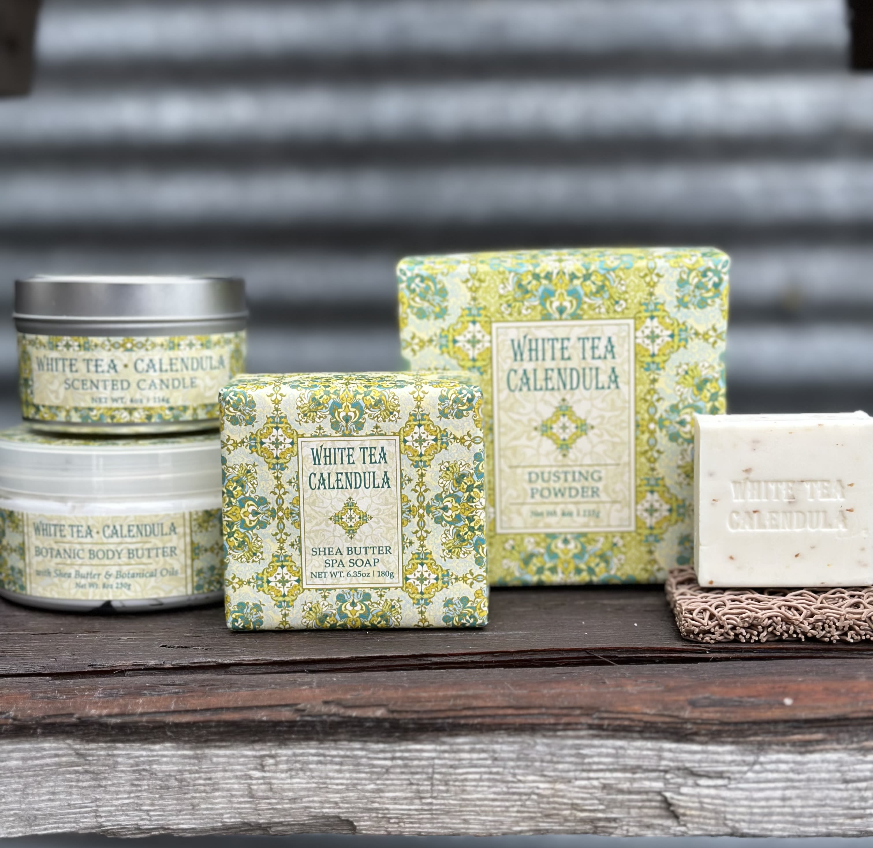 Assorted white tea calendula bath and body products in decorative packaging