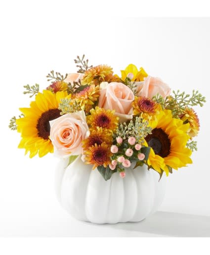 Sunflower and peach rose arrangement in a white pumpkin vase