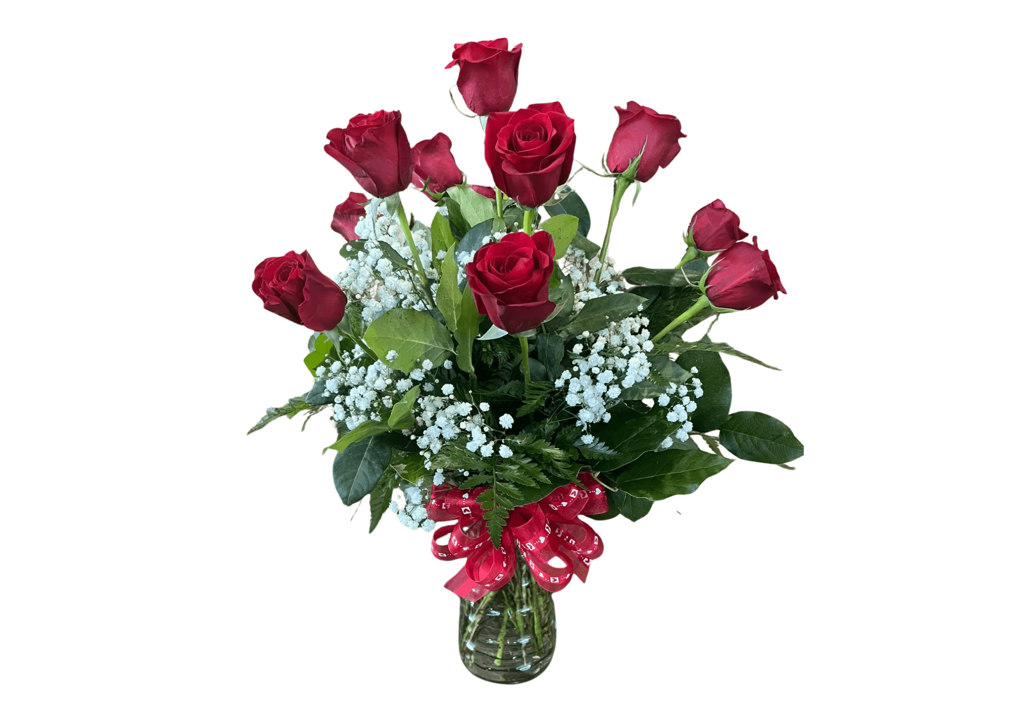 Arrangement of red roses with white filler flowers in a clear glass vase with a red bow