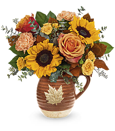 Teleflora's Wild Harvest Bouquet - Warm as the autumnal sun, this joyful sunflower bouquet is perfectly presented in a glazed, food-safe ceramic pitcher that's adorned with a charming maple leaf.