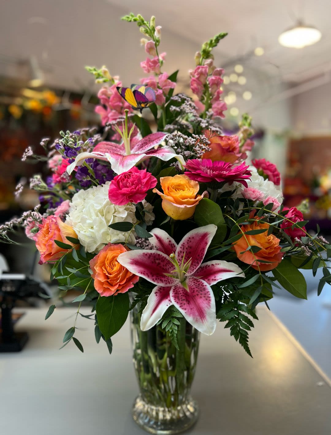 Bright and Lavish - This gorgeous, lavish and bright arrangement is quite the showstopper with its bright orange and pinks. It’s going to have someone say WOW!