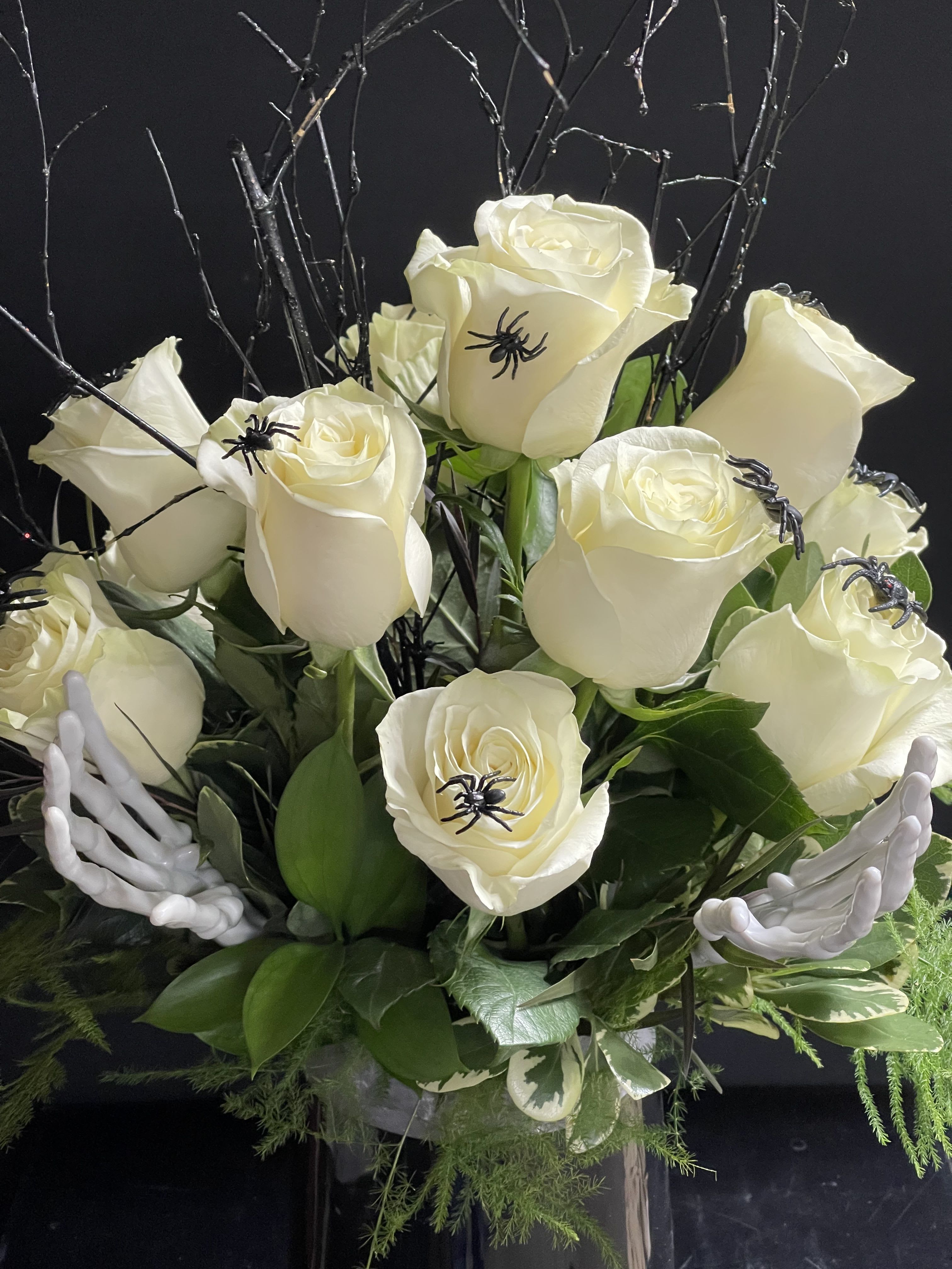 Halloween Dozen White Roses - A dozen white Spooky Roses with spiders, spooky branches, and skeleton hands in a stylish black vase.  Sure to wow and creep your special lady!