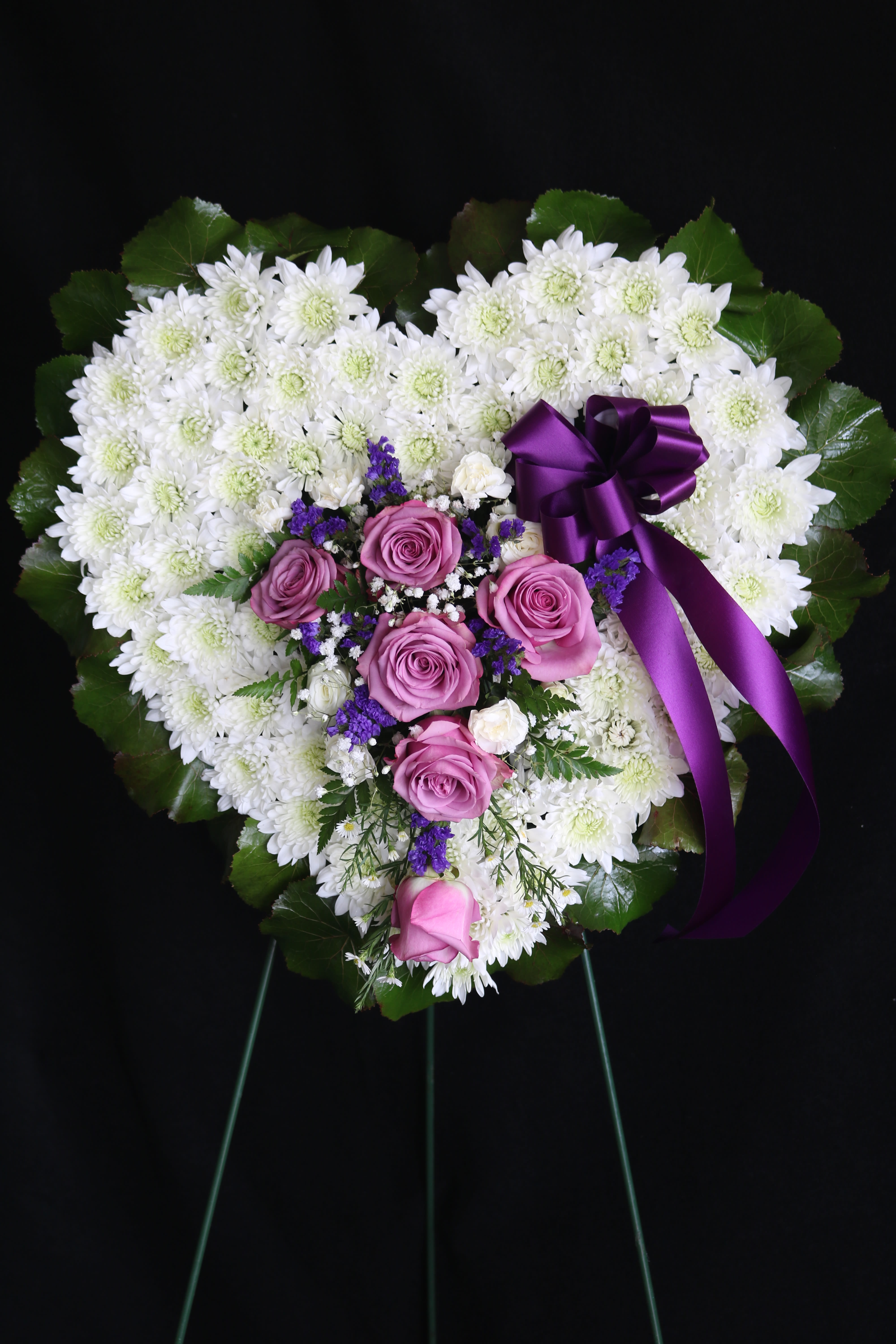Heart-shaped floral spray with white chrysanthemums and pink roses